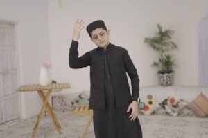 Art of Naat Recitation Muhammad Anas Nazeer posing in a traditional black vest and cap.